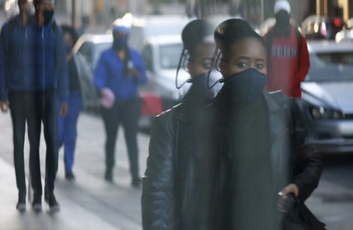 Hình ảnh phản chiếu của một người phụ nữ đeo mặt nạ được bắt gặp ở cửa sổ của một cửa hàng ở Cape Town, Nam Phi, Thứ Tư ngày 17 tháng 6 năm 2020. (Ảnh: Nardus Engelbrecht / AP)