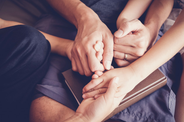 children-holding-hands-praying-with-their-parent-home-family-pray-having-faith-hope_49149-639