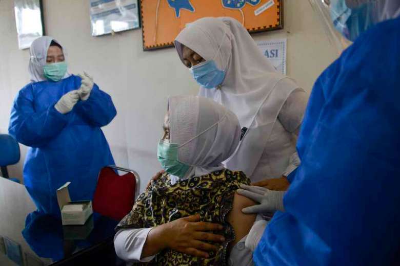 Một nhân viên y tế tiêm vắc xin Sinovac chống lại virus coronavirus tại một trung tâm y tế cộng đồng ở Lambaro thuộc tỉnh Aceh của Indonesia vào ngày 18 tháng 1. (Ảnh: Chaideer Mahyudddin / AFP) 