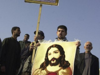 Trong ảnh hồ sơ ngày 19 tháng 1 năm 2004, một người theo đạo Thiên chúa người Iraq cầm trên tay tấm thảm có hình Chúa Giê-su và áp phích của Grand Ayatollah Ali al-Husseini al-Sistani trong một cuộc tuần hành ở Baghdad, Iraq. Vào thứ Bảy, ngày 6 tháng 3 năm 2021, Đức Thánh Cha Phanxicô sẽ đến thăm Grand Ayatollah 90 tuổi, người được nhiều người Shiite trên toàn thế giới tôn kính và lời nói của người có ảnh hưởng mạnh mẽ ở Iraq và hơn thế nữa. Giáo hoàng và ayatollah sẽ gặp nhau tại ngôi nhà khiêm tốn của al-Sistani ở thành phố Najaf của Iraq. (Ảnh: Hadi Mizban / AP)