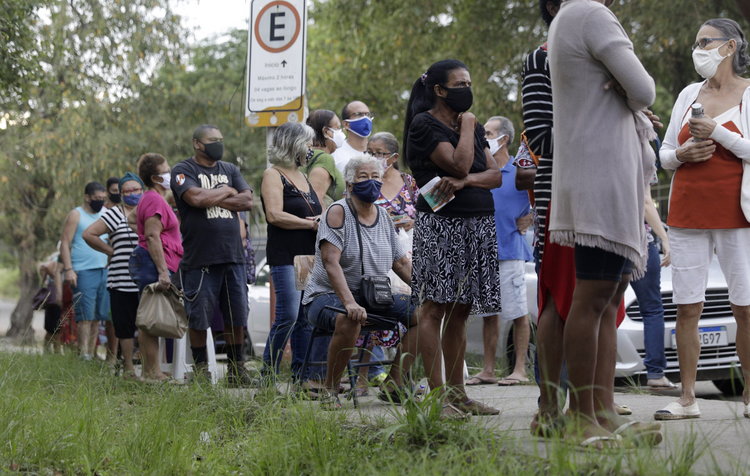 Mọi người chờ đợi bên ngoài một trạm tiêm chủng để nhận một liều vắc-xin Sinovac CoronaVac COVID-19 ở Belford Roxo, Brazil, ngày 31 tháng 3 năm 2021, trong ngày tiêm chủng cho công dân 71 tuổi trở lên. (Ảnh CNS / Ricardo Moraes, Reuters)