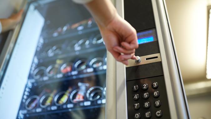 hand-pushing-button-on-vending-machine-shutterstock_597624332